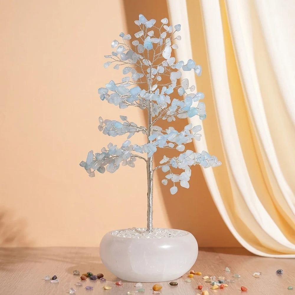 Arbre de Vie "Sérénité Céleste" en aigue-marine avec un tronc argenté et des feuilles bleues claires, posé dans un pot blanc.